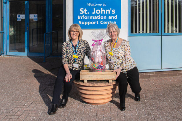 2 women posing with the Easter prize hamper.
