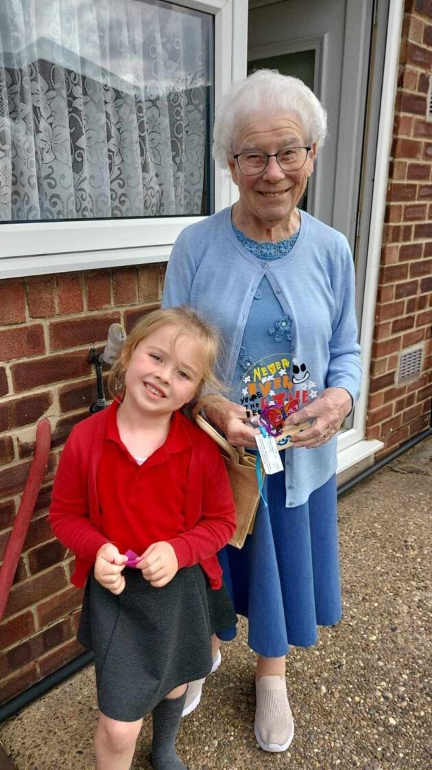 Young girl next to her elderly neighbour