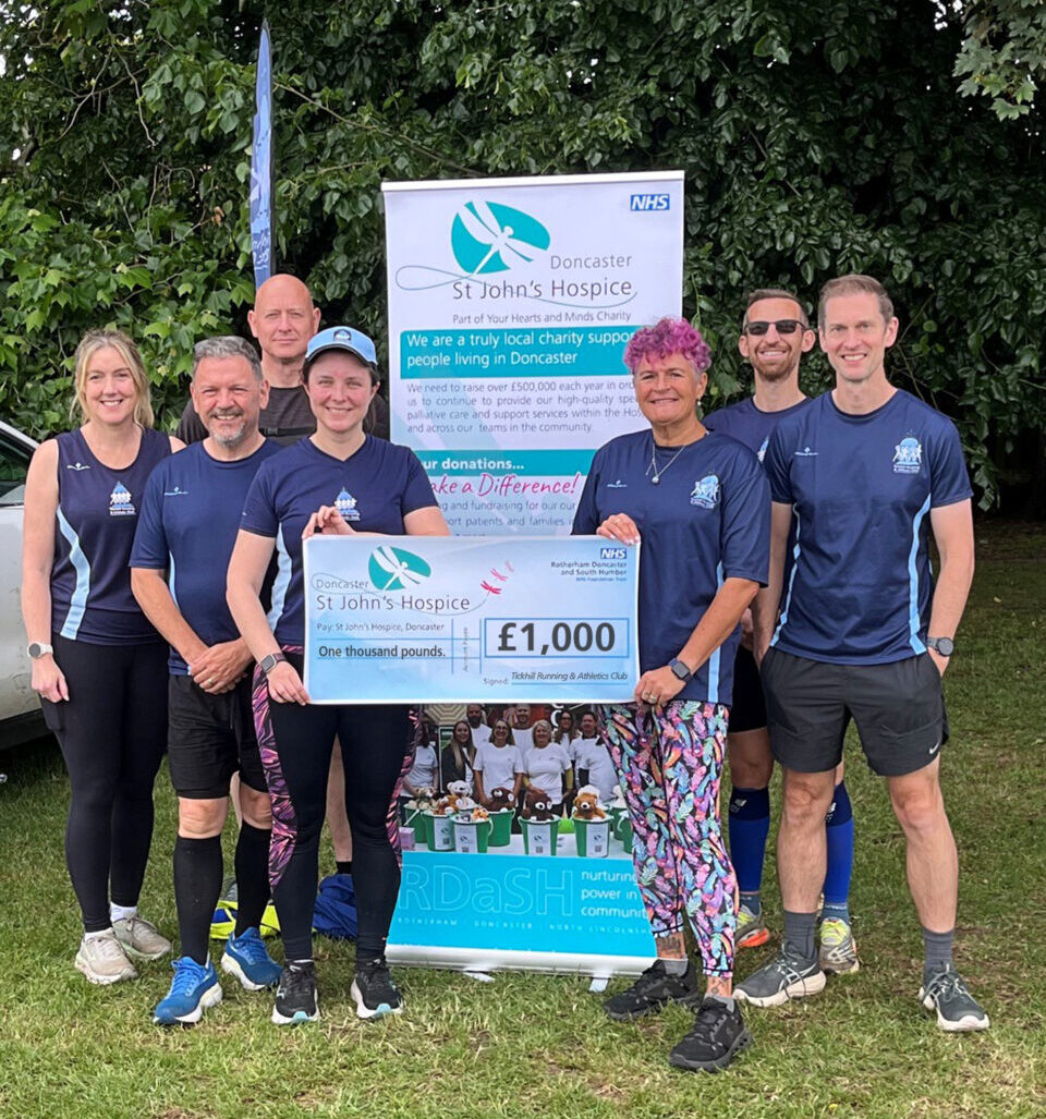 Tickhill Running and Athletic Club holding a cheque for £1,000