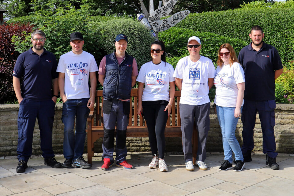 Seven people in front of the Hospice garden
