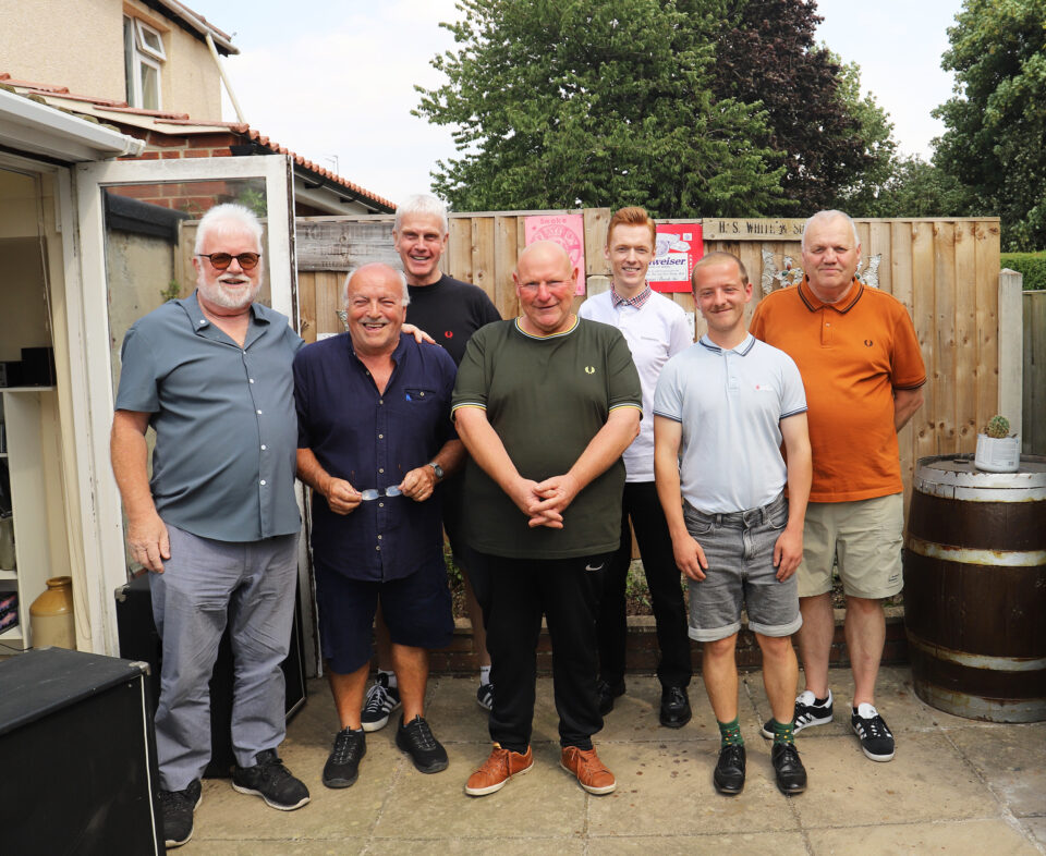Seven people at a garden party